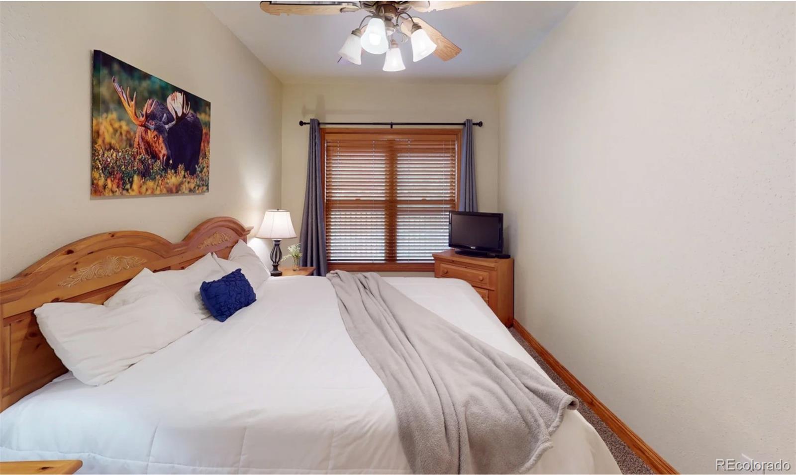 22714 Highway 6, Unit 5945 Keystone, CO 80435 - Photo 37 of 37 a bedroom with a large bed and a chandelier