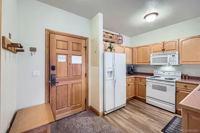 a kitchen with stainless steel appliances granite countertop a refrigerator and a stove top oven
