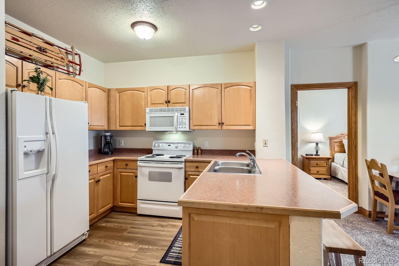 22714 Highway 6, Unit 5945 Keystone, CO 80435 - Photo 7 of 37 a kitchen with a sink a stove and refrigerator