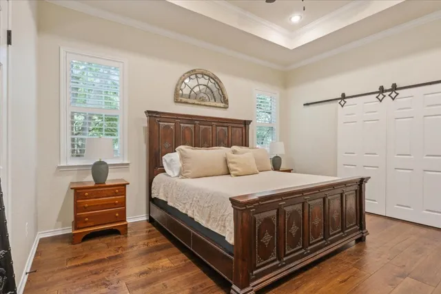 a bed sitting in a spacious bedroom next to a window