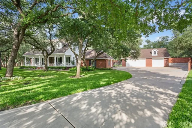 a front view of a house with a yard and trees