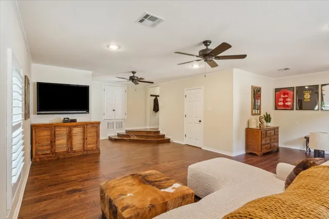 a living room with furniture and a wooden floor