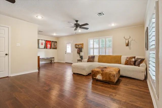 a bathroom with a granite countertop sink toilet and mirror