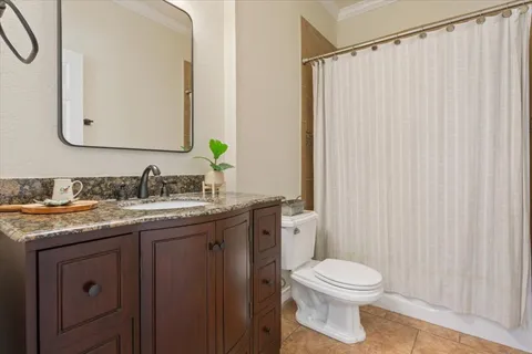 an empty room with windows and ceiling fan
