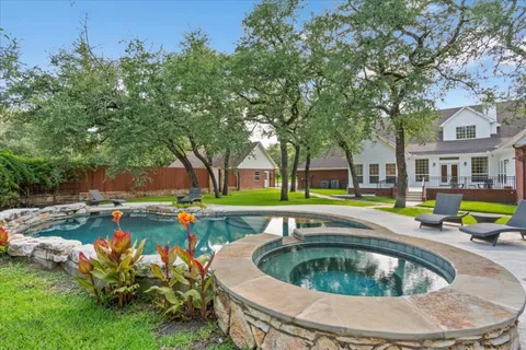 a view of a backyard with large trees