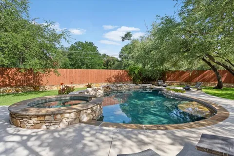a view of a patio with table and chairs under an umbrella