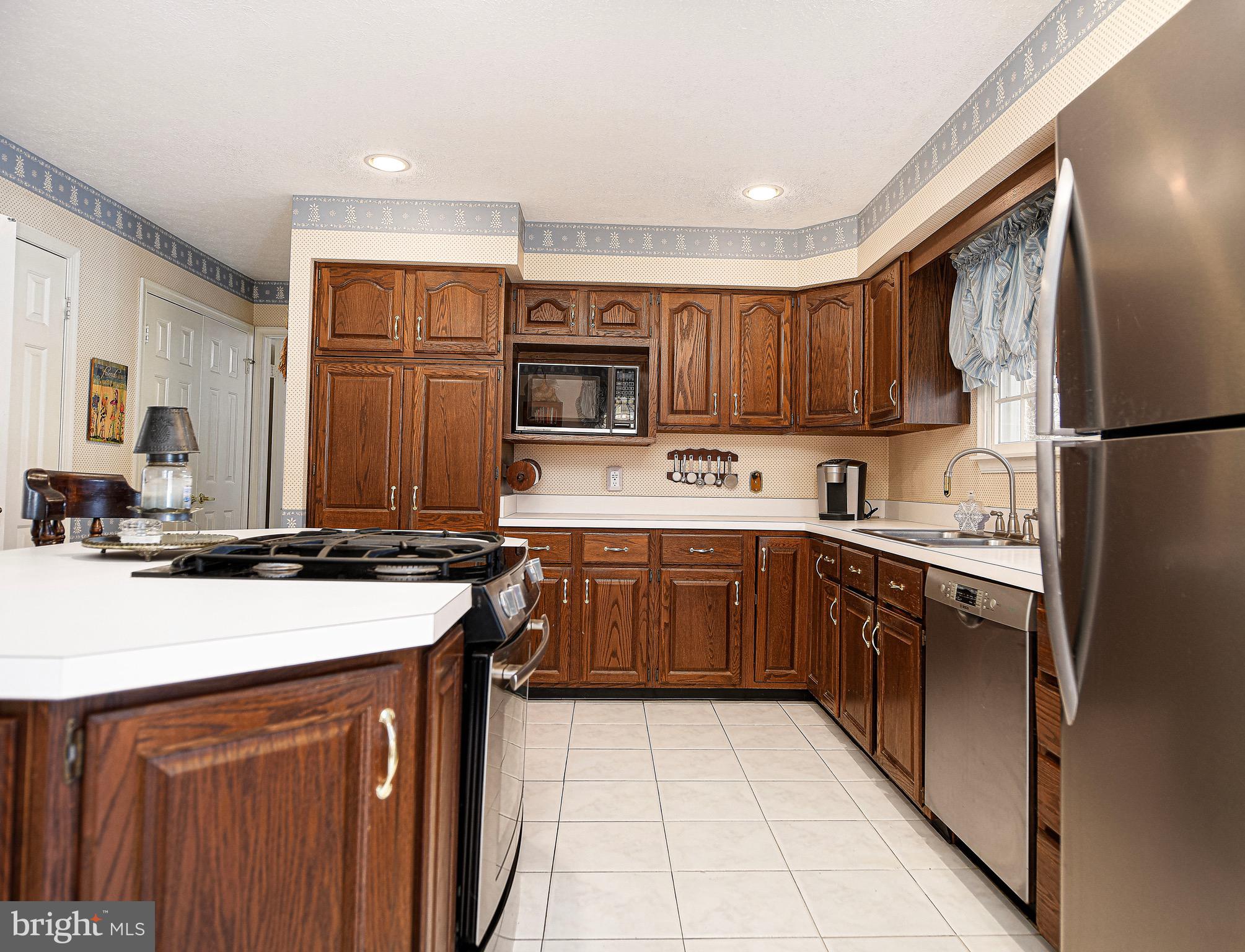 627 Northgate Road Aberdeen, MD 21001 - Photo 13 of 43 a kitchen with kitchen island granite countertop a sink stove and refrigerator