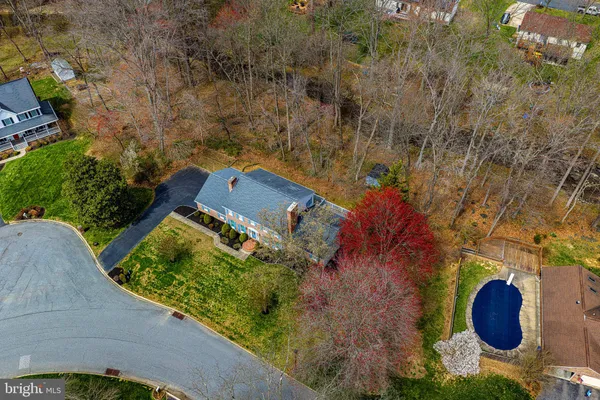 an aerial view of a house with garden space and sitting area