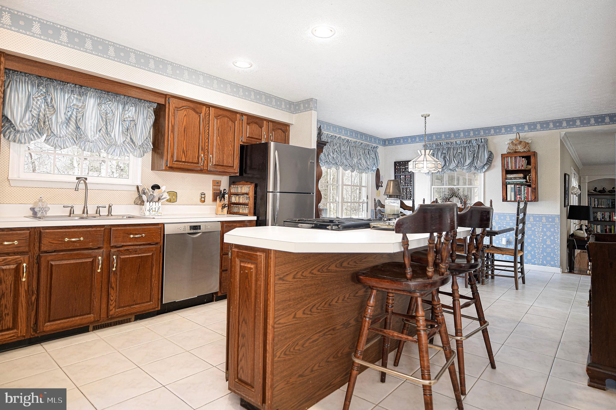627 Northgate Road Aberdeen, MD 21001 - Photo 10 of 43 a kitchen with stainless steel appliances kitchen island granite countertop a table chairs sink and cabinets