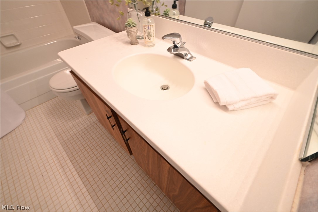 22962 Maple Ridge Road, Unit 206 North Olmsted, OH 44070 - Photo 20 of 33 Full bathroom with tile floors, shower / bath combination, vanity with extensive cabinet space, and toilet