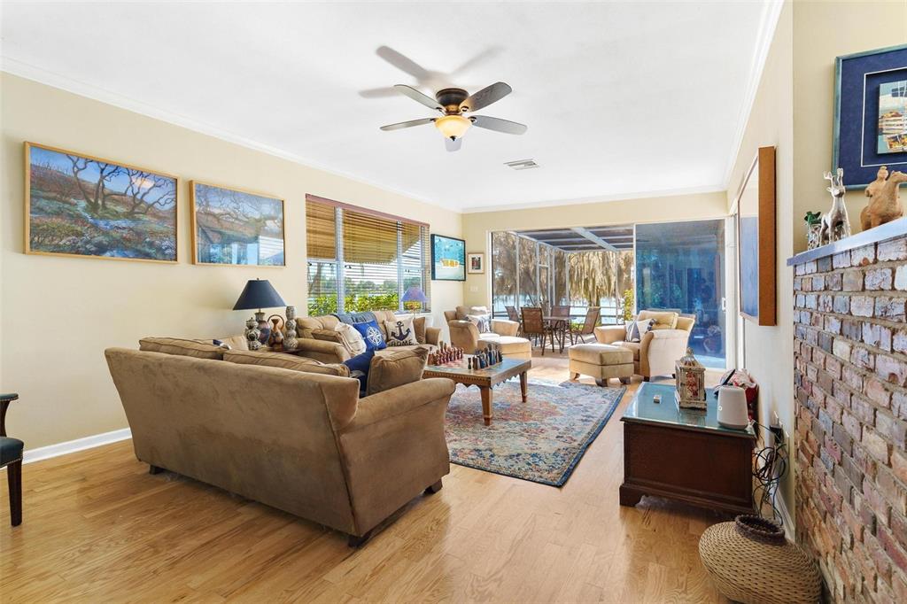 475 Guerrant Street Umatilla, FL 32784 - Photo 12 of 63 a living room with furniture wooden floor and a large window