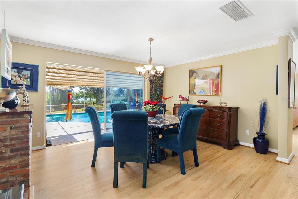 475 Guerrant Street Umatilla, FL 32784 - Photo 13 of 63 a dining room with furniture a chandelier and wooden floor