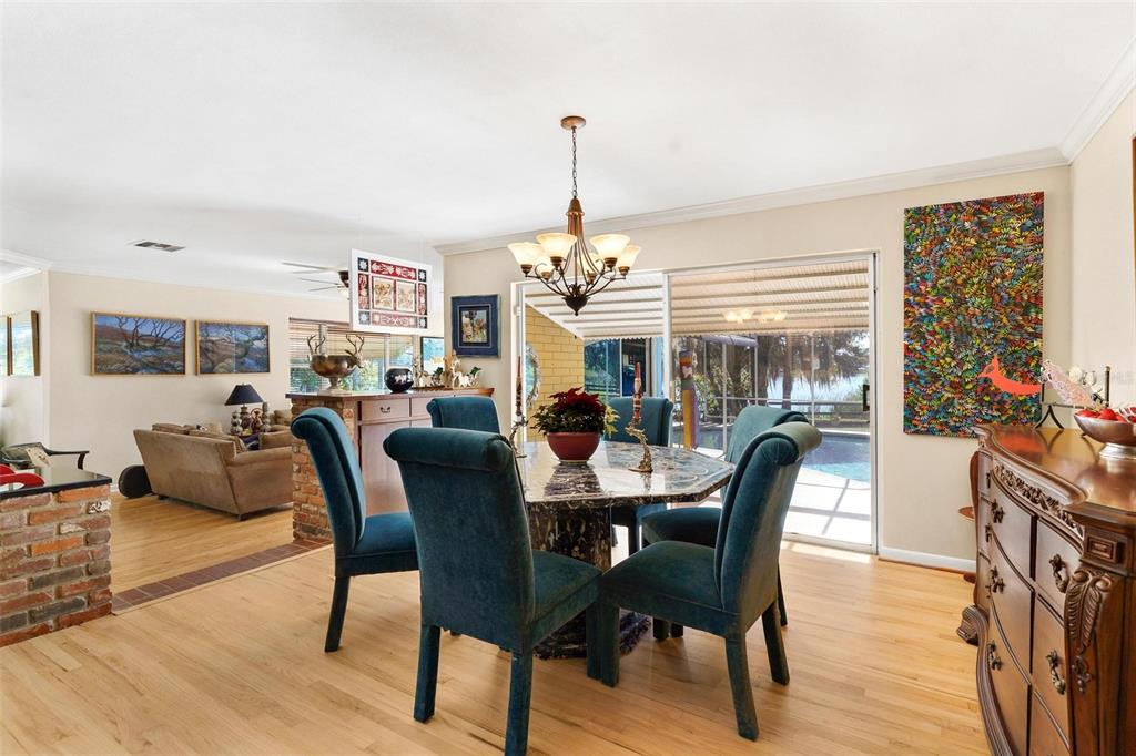 475 Guerrant Street Umatilla, FL 32784 - Photo 14 of 63 a dining room with furniture a chandelier and wooden floor