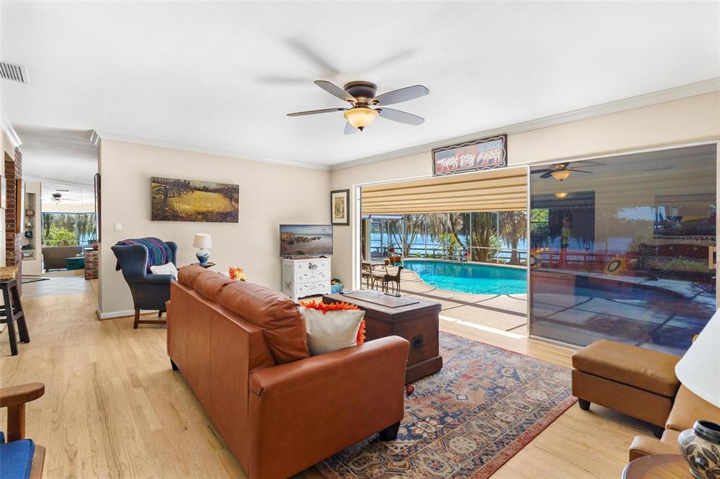 475 Guerrant Street Umatilla, FL 32784 - Photo 20 of 63 a living room with furniture floor to ceiling window and garden view