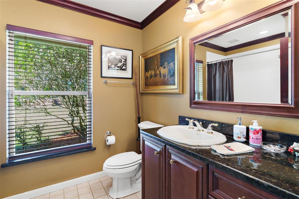 475 Guerrant Street Umatilla, FL 32784 - Photo 35 of 63 a bathroom with a granite countertop toilet sink and mirror
