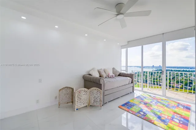 a living room with furniture and a floor to ceiling window