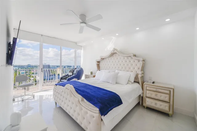 a spacious bedroom with a large bed and a large window