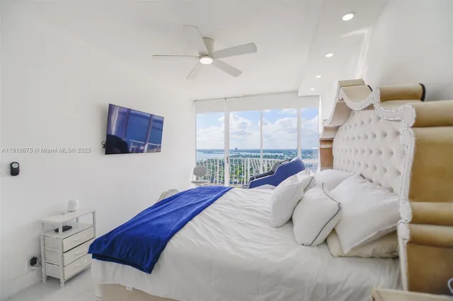 a bedroom with a large bed and a window