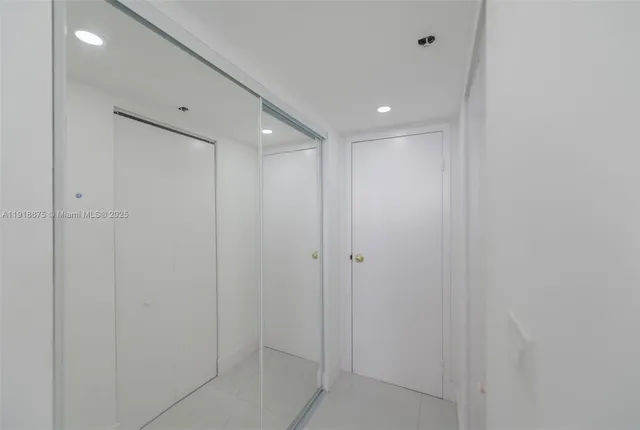 a bathroom with a shower and a glass door