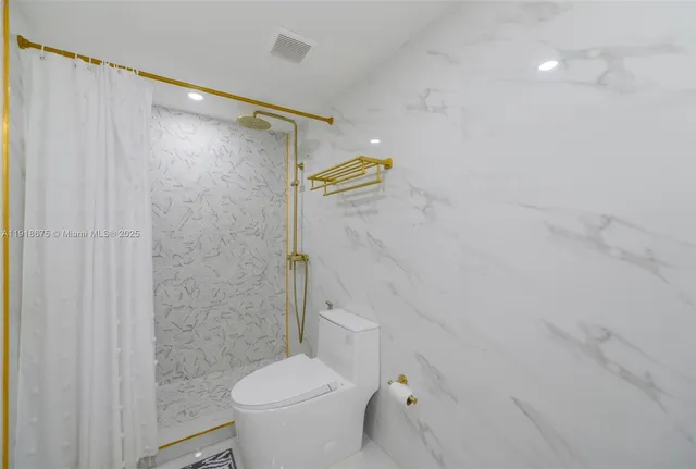 a bathroom with a shower and a toilet