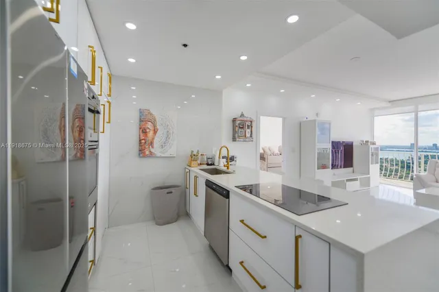 a kitchen with stainless steel appliances granite countertop a refrigerator and a sink