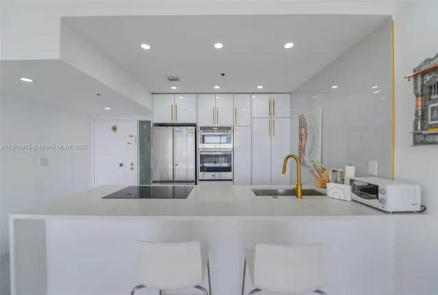 a kitchen with stainless steel appliances refrigerator and microwave