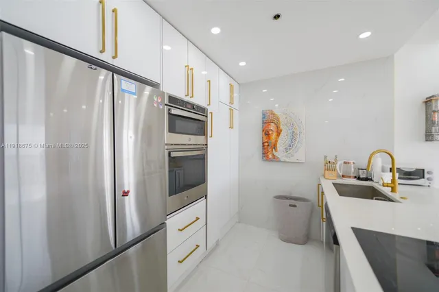 a kitchen with stainless steel appliances a refrigerator and a sink