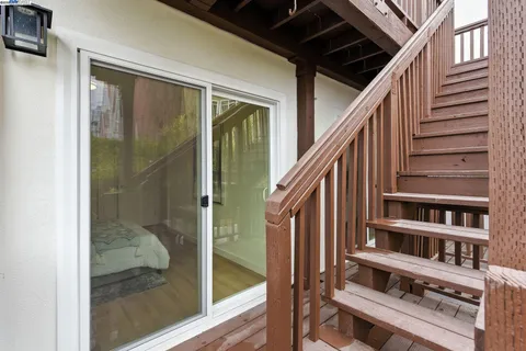 a view of staircase with large window and wooden floor