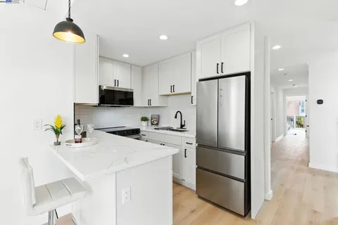 a kitchen with stainless steel appliances a refrigerator sink and microwave