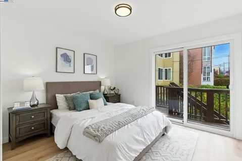 a bedroom with a bed and a lamp next to a window