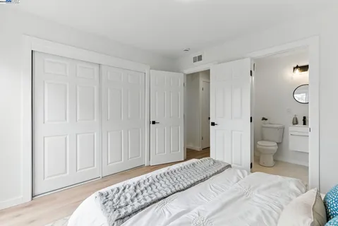 a bedroom with a bed and a toilet