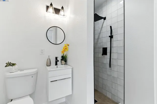 a bathroom with a sink toilet and a mirror