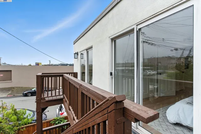 a kitchen with a refrigerator a microwave a stove and white cabinets with wooden floor