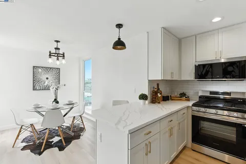 a kitchen with a sink cabinets and stainless steel appliances