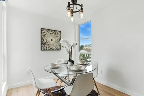 a dining room with furniture and wooden floor