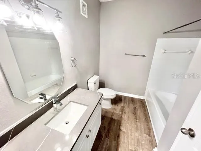 a bathroom with a sink a mirror and a shower