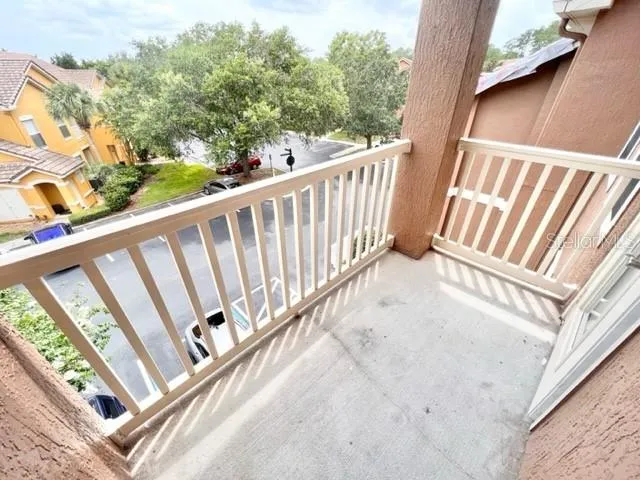 a view of a balcony with wooden floor
