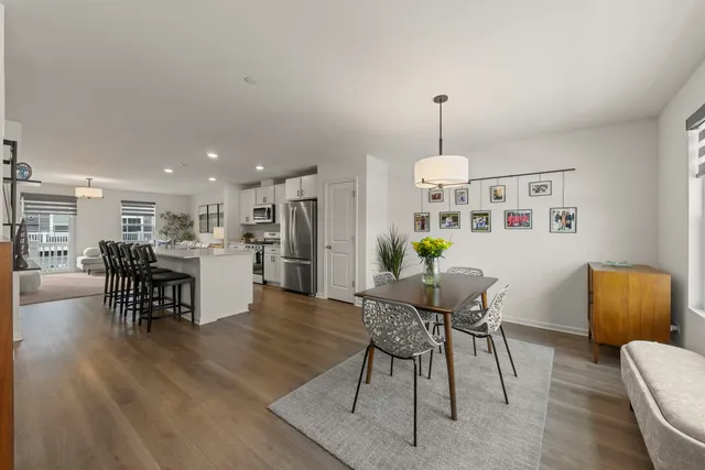 a living room with furniture and kitchen view