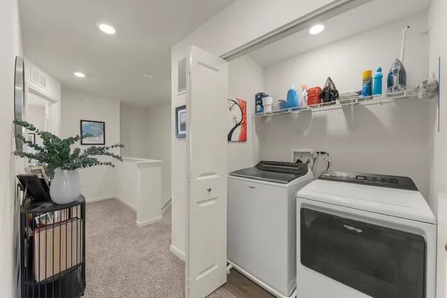 a utility room with sink dryer and washer