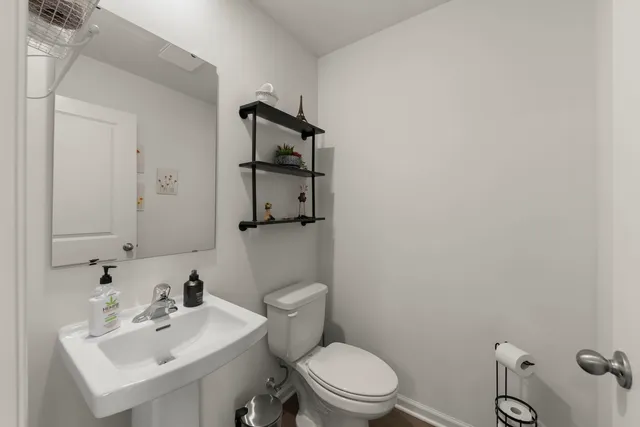 a white toilet sitting next to a bathroom sink