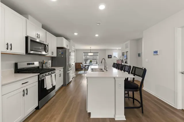 a kitchen with sink a microwave and cabinets