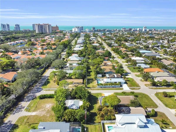 an aerial view of residential houses with city view