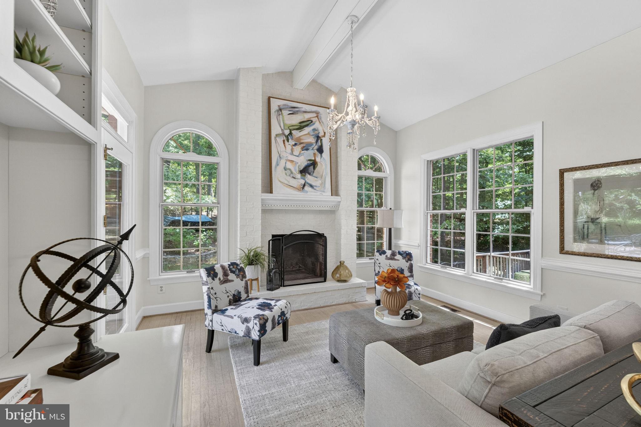 4531 Den Haag Road Warrenton, VA 20187 - Photo 13 of 103 a living room with furniture a chandelier and a fireplace