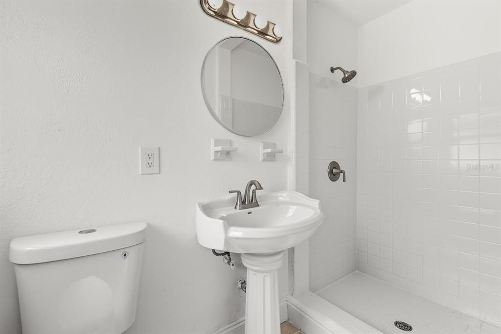 1816 Ivy Lane Winter Park, FL 32792 - Photo 13 of 35 a bathroom with a sink a toilet and a mirror