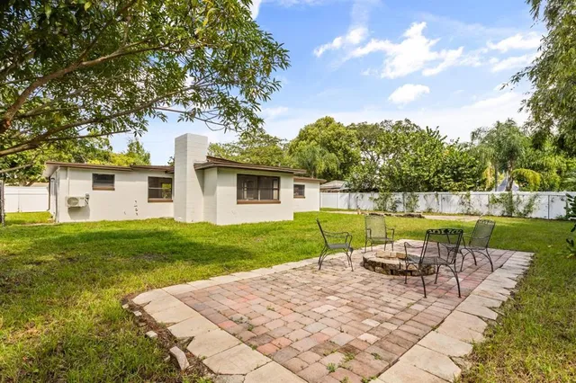 a view of a house with swimming pool and a yard