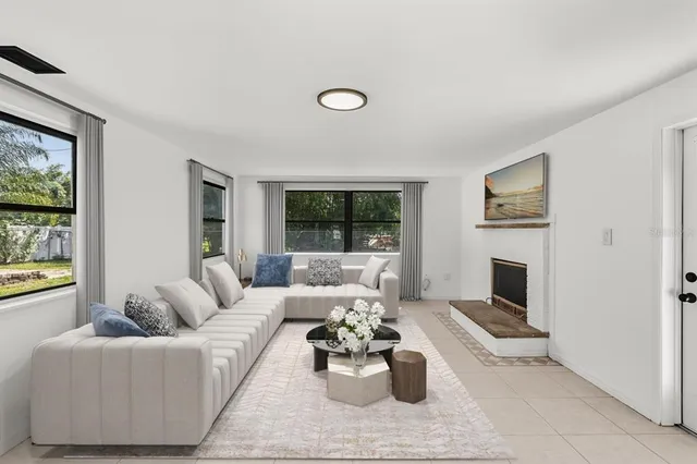 a living room with furniture wooden floor and a fireplace