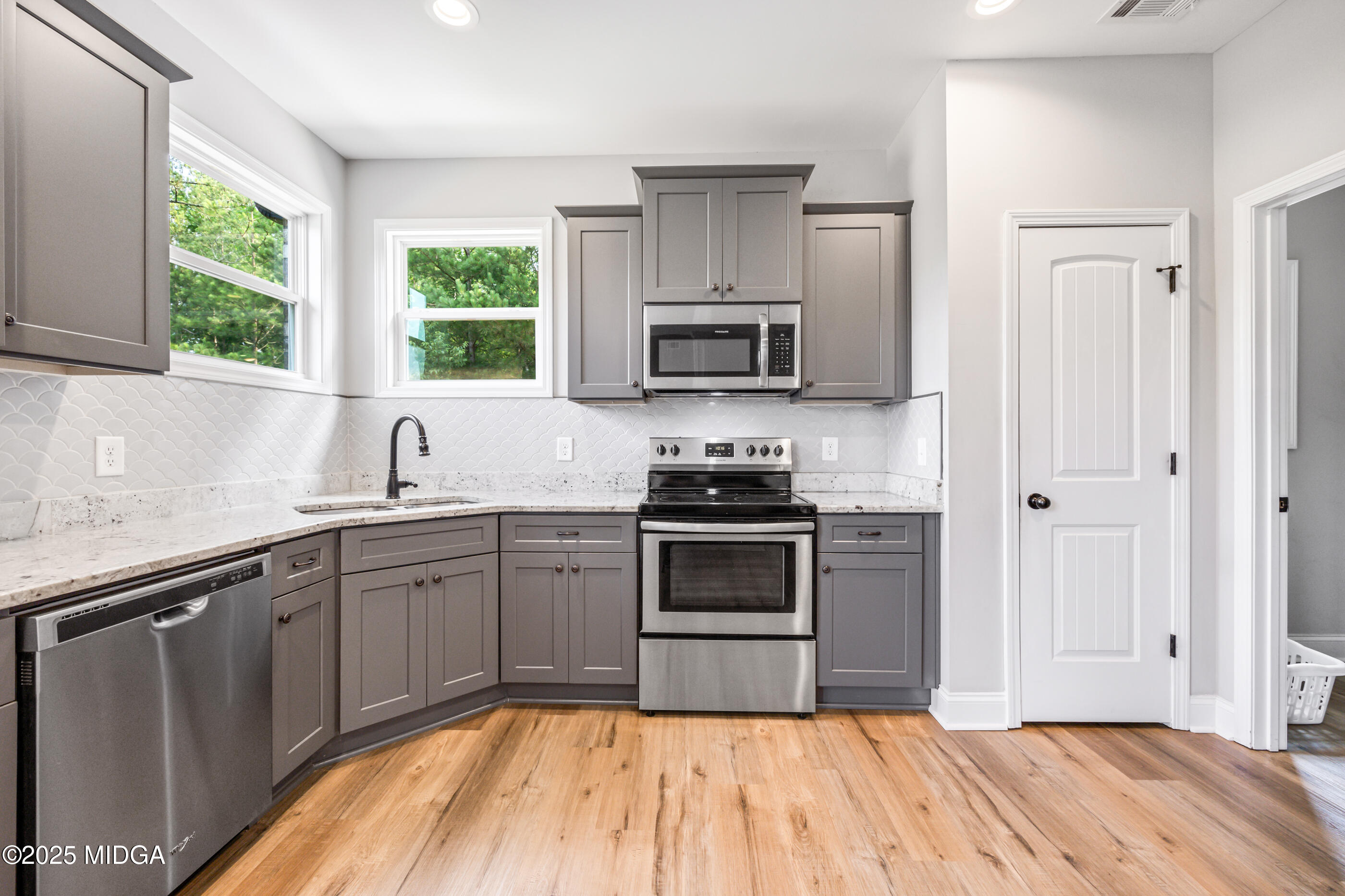 36 River Rapids Drive Forsyth, GA 31029 - Photo 12 of 57 a kitchen with a sink stove and microwave