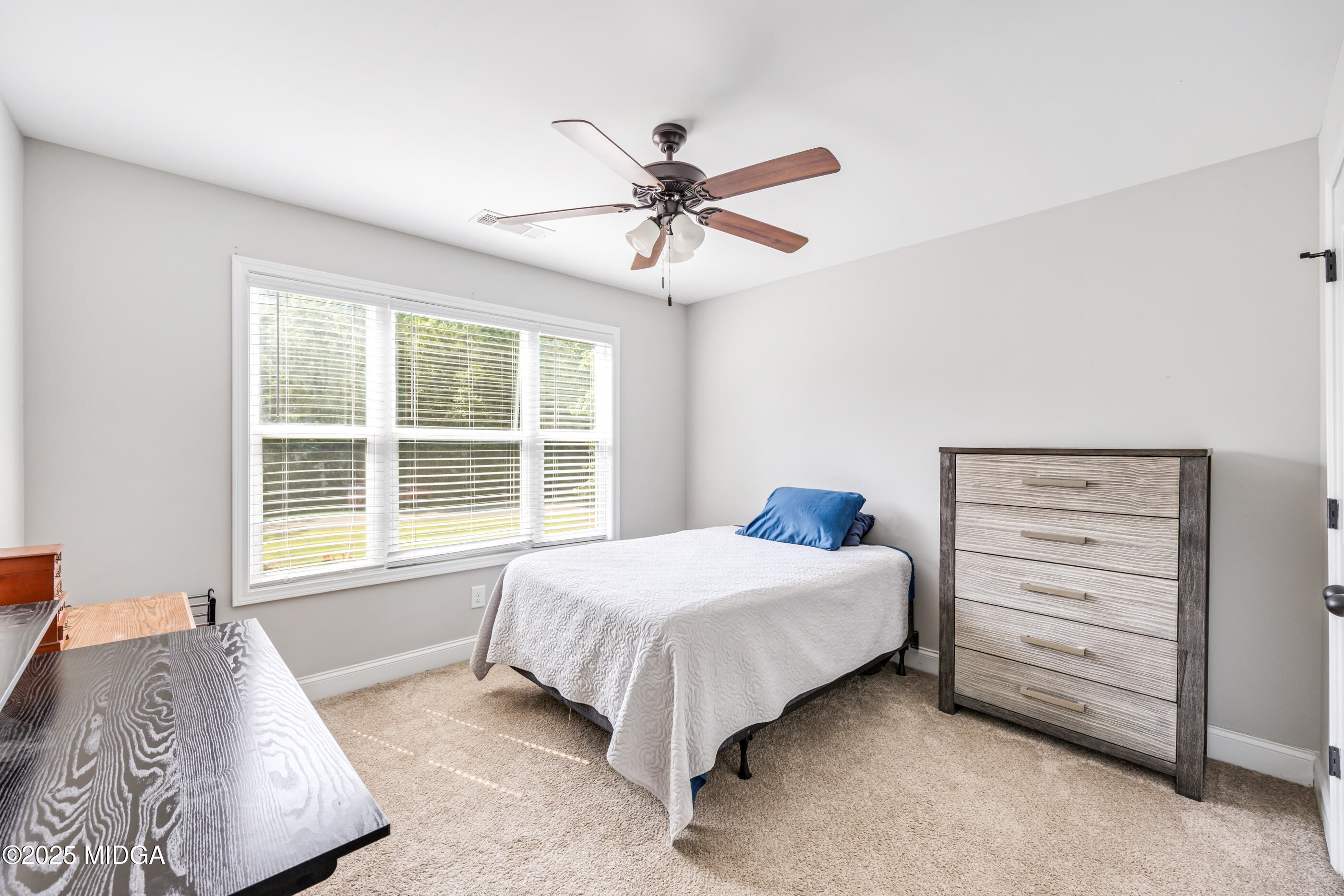 36 River Rapids Drive Forsyth, GA 31029 - Photo 20 of 57 a bedroom with a bed and a window