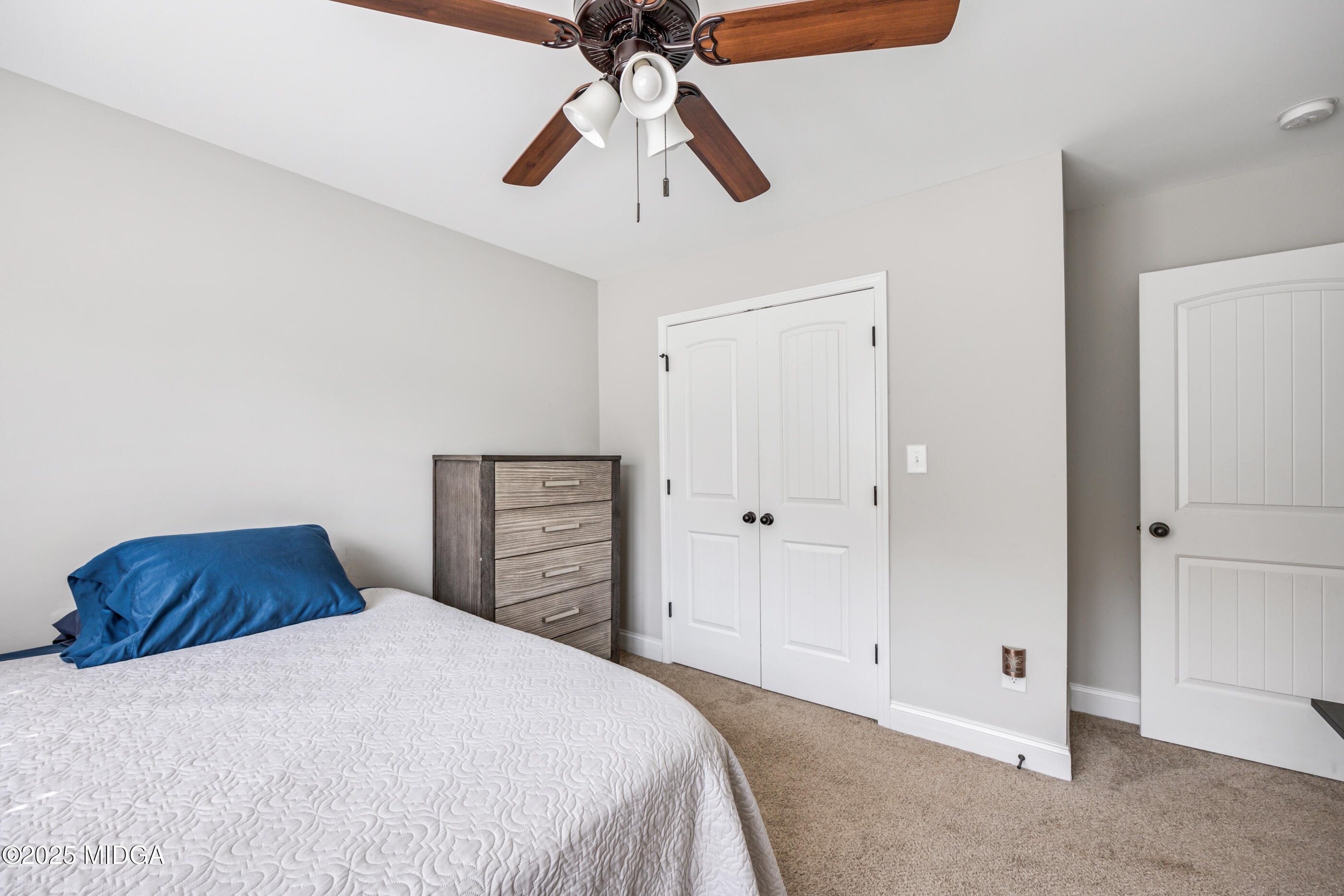 36 River Rapids Drive Forsyth, GA 31029 - Photo 21 of 57 a bedroom with a bed and a chandelier