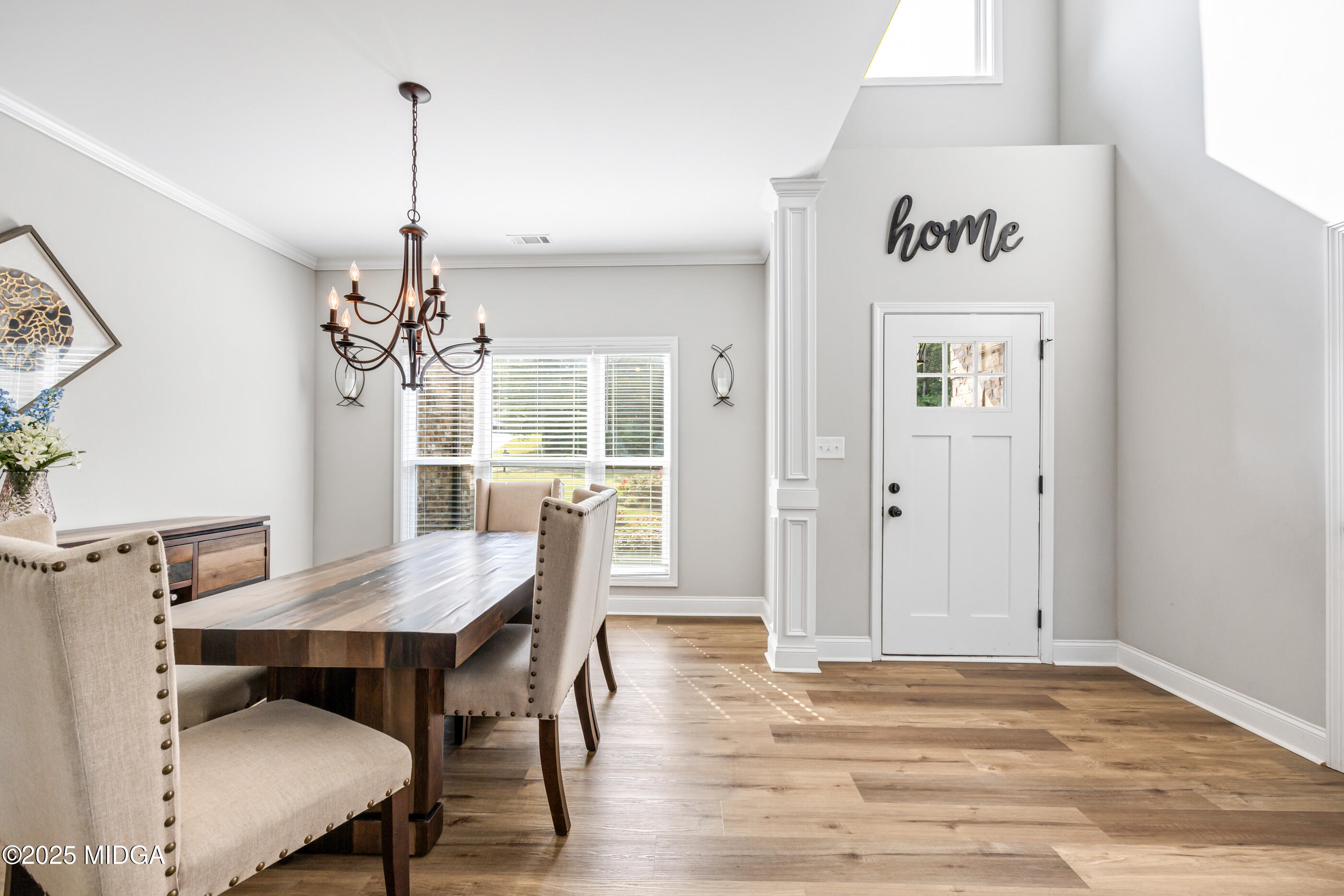 36 River Rapids Drive Forsyth, GA 31029 - Photo 3 of 57 a view of a dining room with furniture and wooden floor